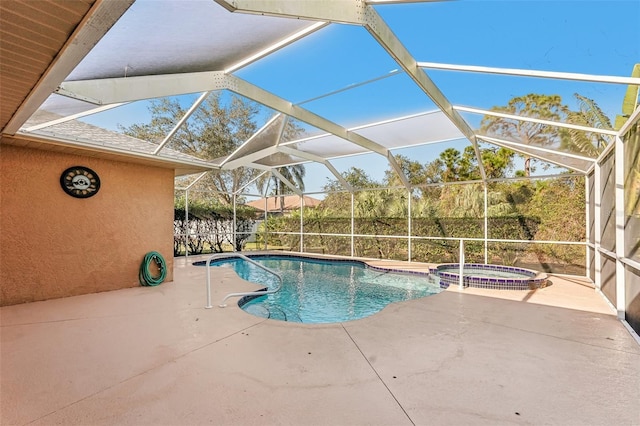 view of swimming pool with an in ground hot tub, a patio, and glass enclosure