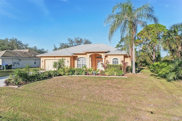 single story home featuring a garage and a front lawn