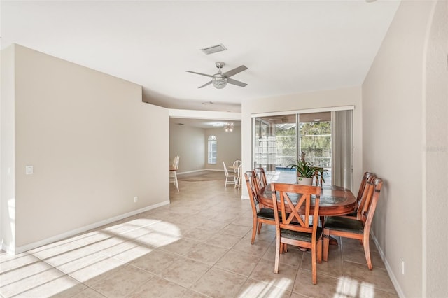 dining space featuring a ceiling fan, light tile patterned flooring, and baseboards
