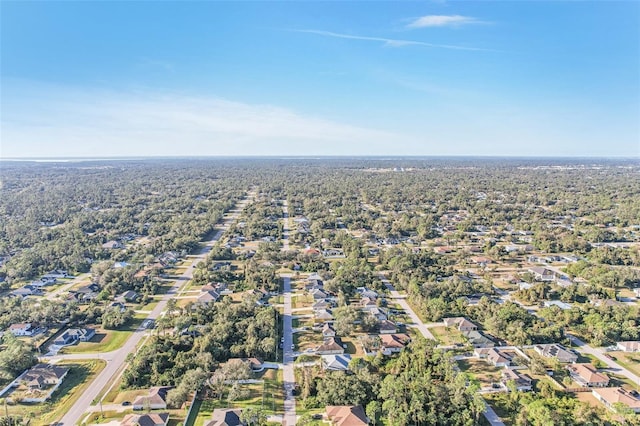 aerial view of property and surrounding area with nearby suburban area