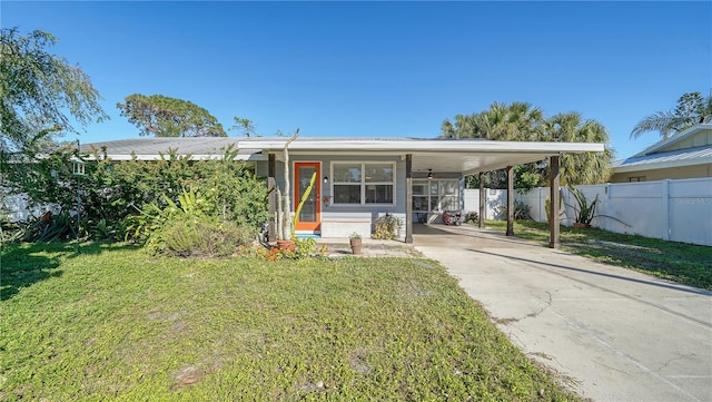 view of front of home with a front yard and a carport