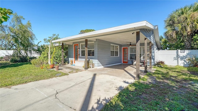 view of front of property with a front yard and a carport