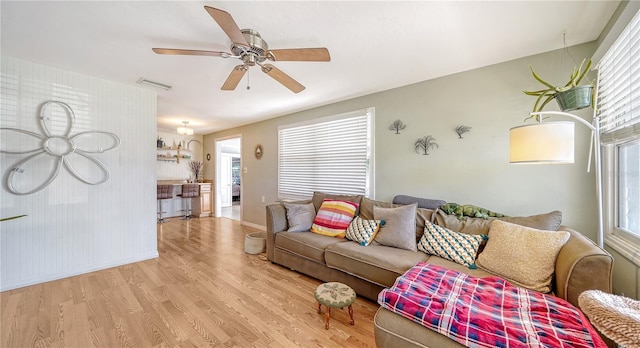 living room featuring a wealth of natural light, ceiling fan, and light hardwood / wood-style floors