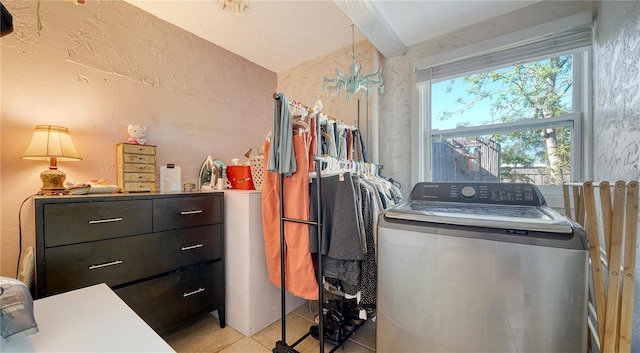 laundry area with washer / dryer and light tile patterned floors