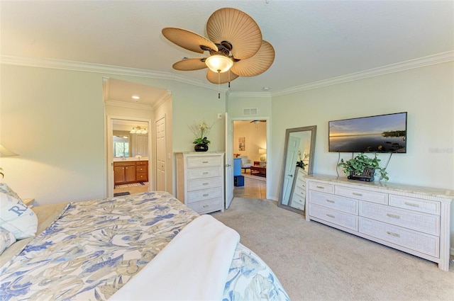 carpeted bedroom featuring crown molding, ceiling fan, and ensuite bath