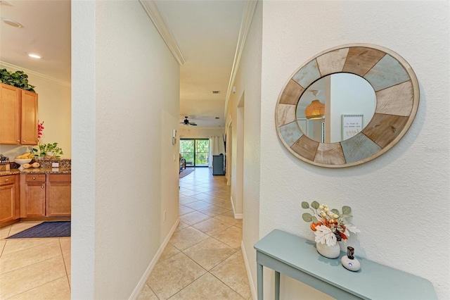 hallway with crown molding and light tile patterned flooring