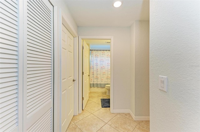 corridor featuring light tile patterned floors