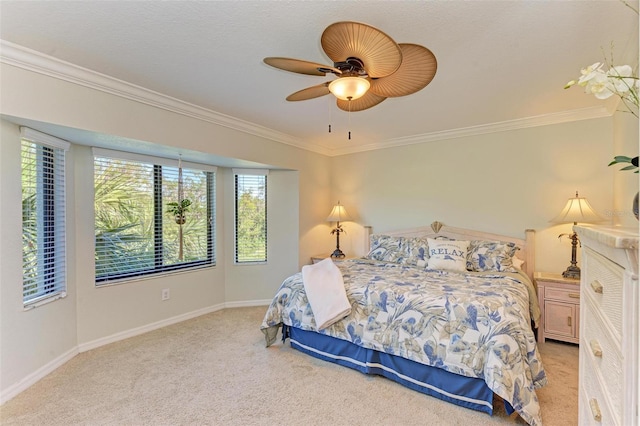 bedroom featuring ceiling fan, ornamental molding, and light colored carpet