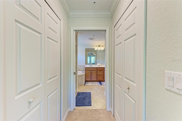 hall featuring crown molding and light colored carpet