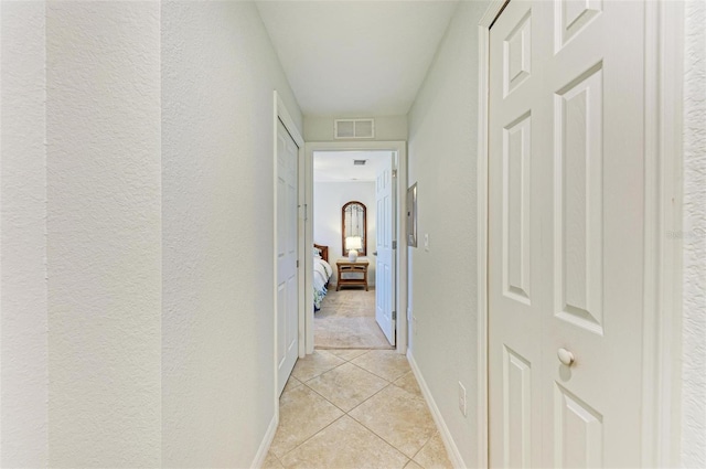 hallway with light tile patterned flooring