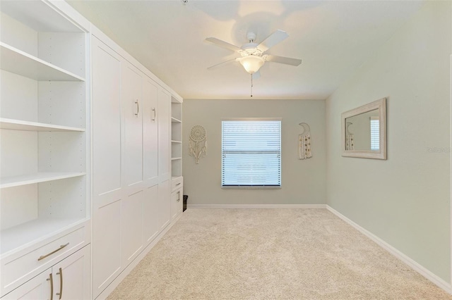 unfurnished room featuring light carpet and ceiling fan