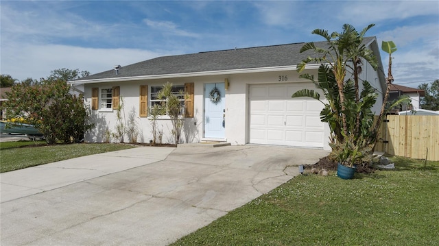 ranch-style home featuring a garage and a front lawn