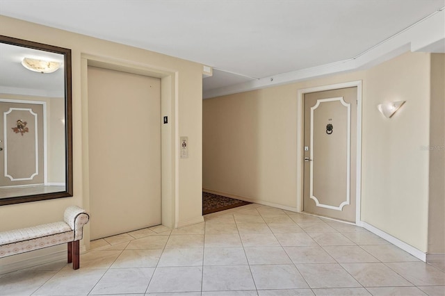 hallway with light tile patterned floors and elevator