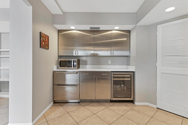 bar with light tile patterned floors and wine cooler