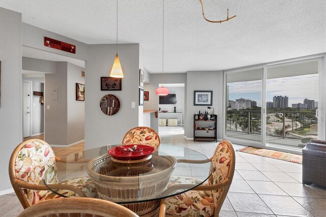 dining room featuring light tile patterned floors and a textured ceiling