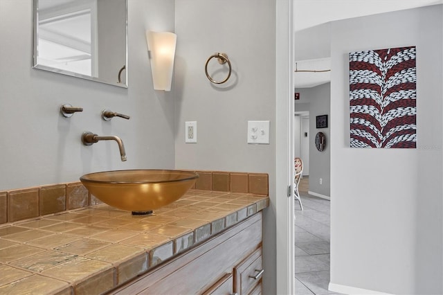 bathroom featuring tile patterned flooring and vanity