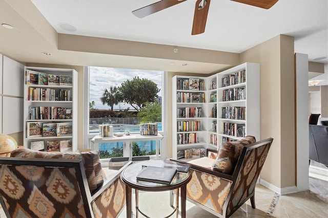 sitting room with light tile patterned floors and ceiling fan