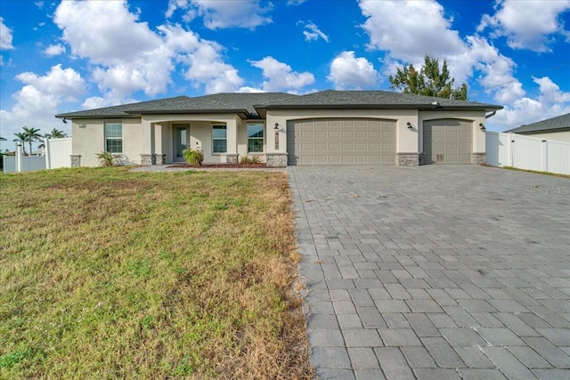 view of front of property featuring a front lawn and a garage