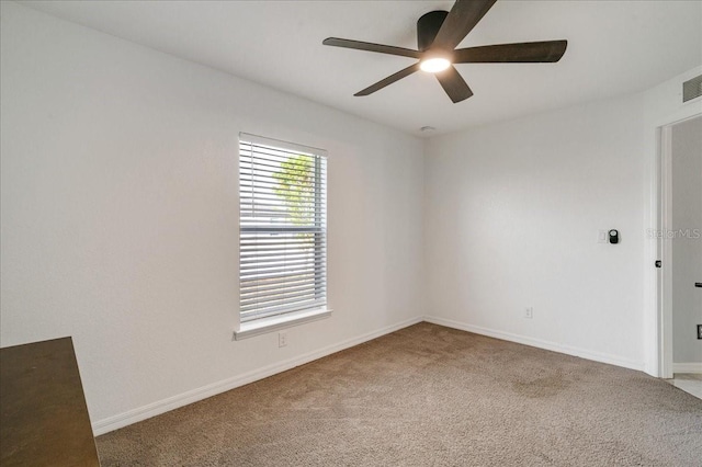 empty room featuring carpet floors and ceiling fan