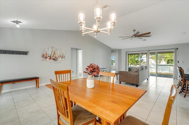 tiled dining space featuring lofted ceiling and ceiling fan with notable chandelier