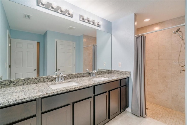 bathroom with a shower with shower curtain, tile patterned flooring, and vanity