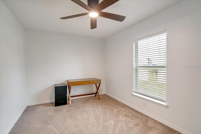 unfurnished room with ceiling fan and light carpet