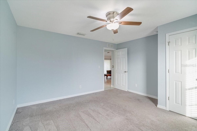 unfurnished bedroom featuring ceiling fan and light carpet