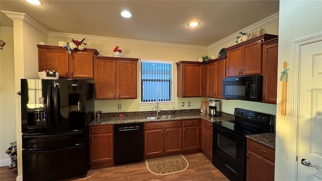 kitchen featuring crown molding, dark wood-type flooring, sink, and black appliances