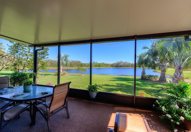 sunroom / solarium with a water view