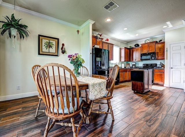 dining room with ornamental molding and dark hardwood / wood-style flooring