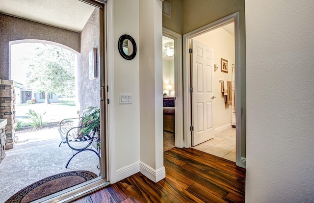 foyer featuring ceiling fan and wood-type flooring