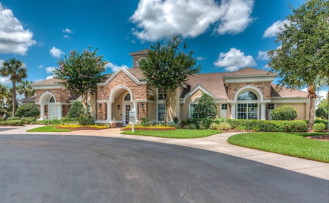 mediterranean / spanish house with a front yard