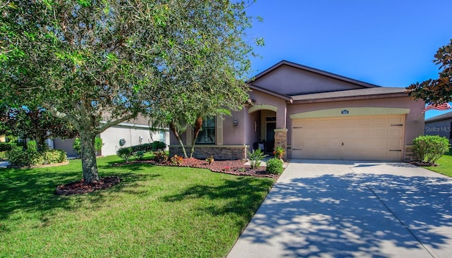 view of front of property featuring a front lawn, concrete driveway, stucco siding, a garage, and stone siding