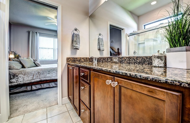 bathroom featuring tile patterned floors, a ceiling fan, connected bathroom, a shower stall, and vanity