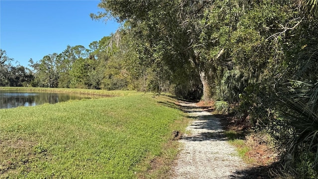 view of road featuring a view of trees and a water view