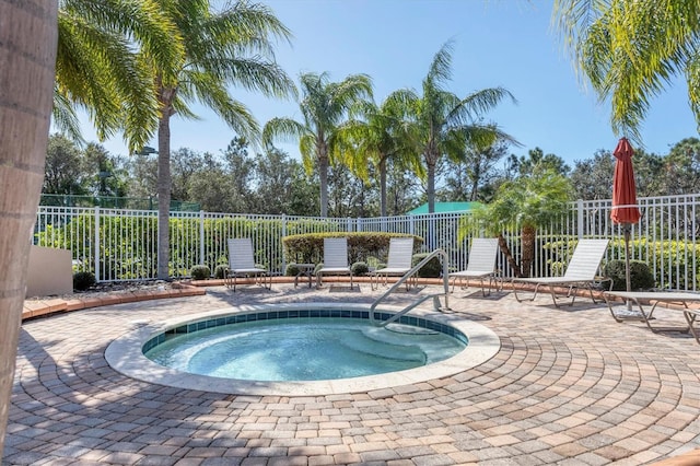 view of swimming pool with a patio and a hot tub