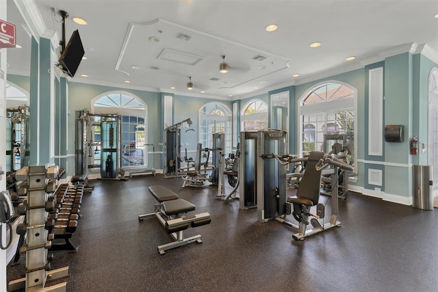 gym featuring ceiling fan and ornamental molding