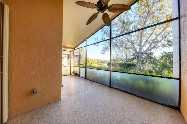 unfurnished sunroom with vaulted ceiling and ceiling fan