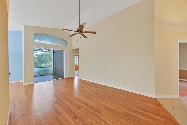 spare room featuring ceiling fan, light hardwood / wood-style floors, and high vaulted ceiling