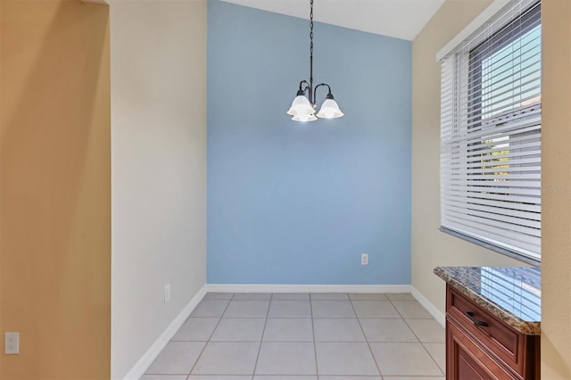 unfurnished dining area featuring light tile patterned flooring, lofted ceiling, and a chandelier