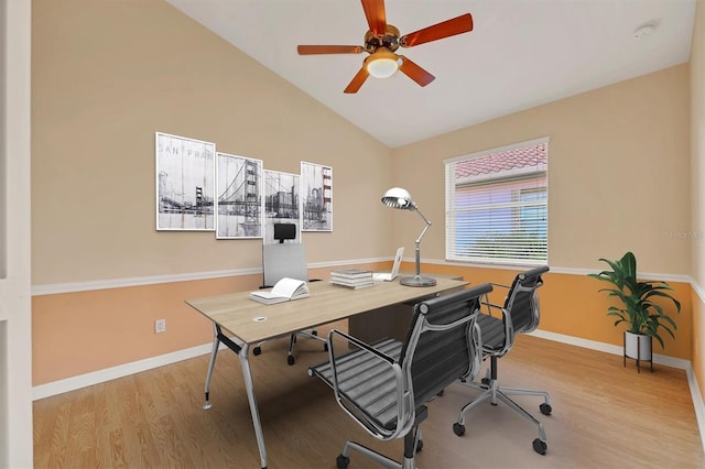 office space featuring ceiling fan, lofted ceiling, and light wood-type flooring