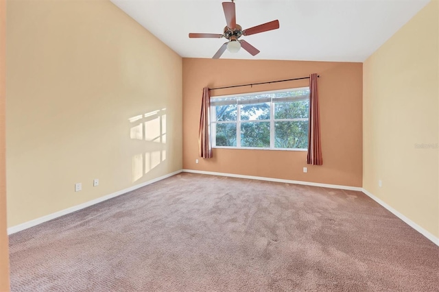 carpeted empty room with ceiling fan and vaulted ceiling