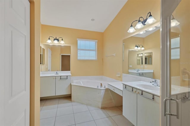 bathroom with tile patterned floors, a bathtub, and vanity