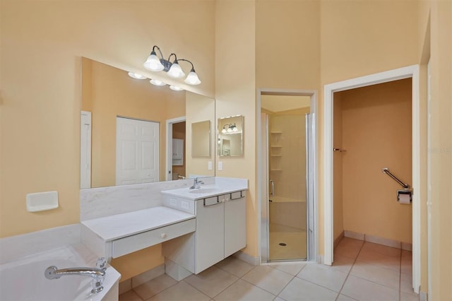 bathroom with tile patterned flooring, a high ceiling, vanity, and separate shower and tub