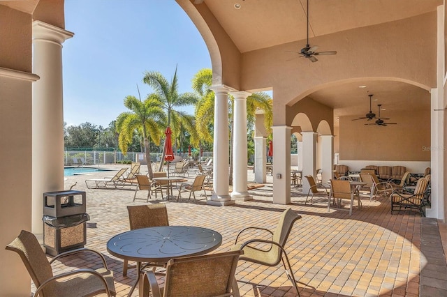 view of patio / terrace with ceiling fan and a community pool