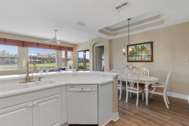 kitchen featuring dishwasher, white cabinets, ceiling fan with notable chandelier, sink, and light wood-type flooring