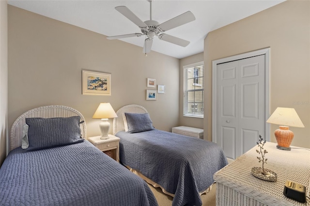 carpeted bedroom featuring ceiling fan and a closet