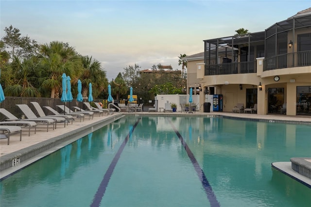 view of swimming pool featuring a lanai and a patio