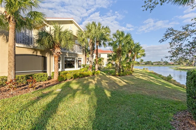 view of yard featuring a balcony and a water view