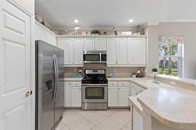 kitchen with kitchen peninsula, white cabinets, and appliances with stainless steel finishes